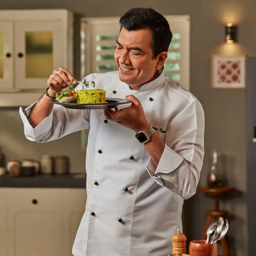 Chef Sanjeev Kapoor plating a dish