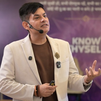 Anurag Rishi speaking on stage