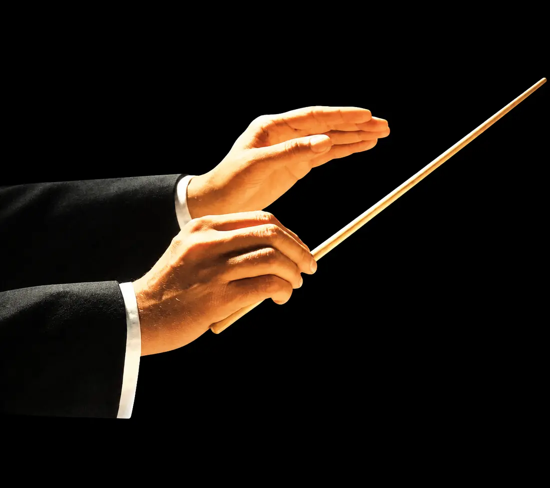 Conductor's hands holding a baton